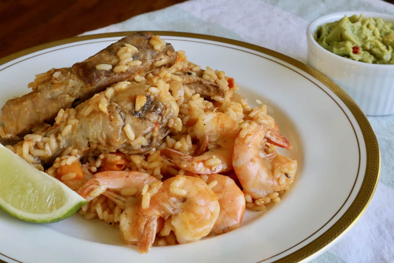 Serve Mexican Paella with fresh lime and guacamole.