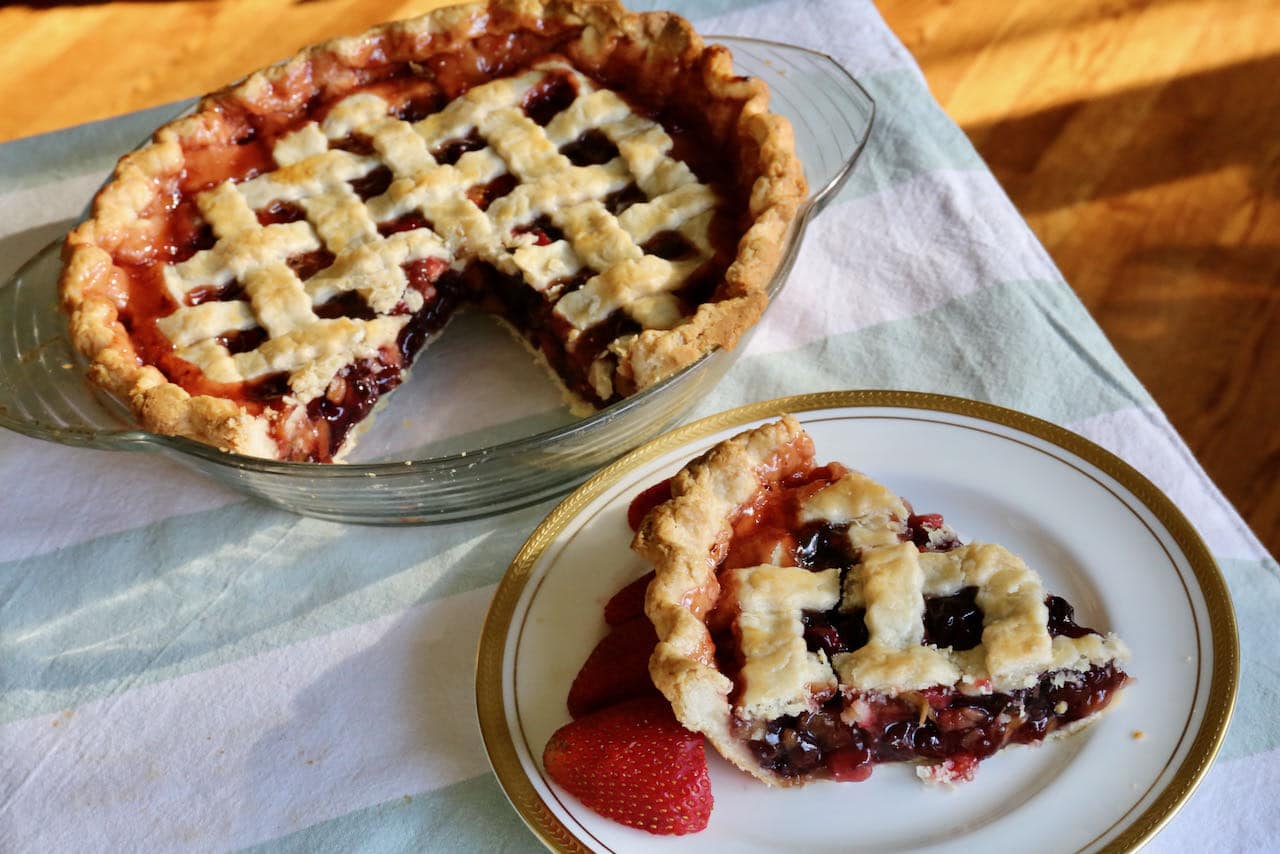 Serve Rhubarb Cherry Pie with ice cream and fresh berries.