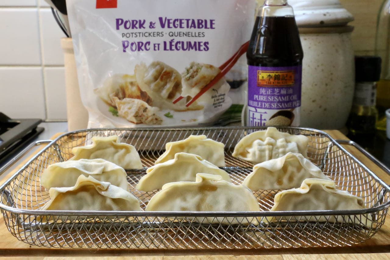 Our simple Frozen Air Fryer Dumplings recipe features store bought potstickers and sesame oil.
