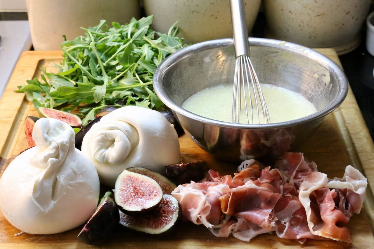 This easy Italian salad features Burrata cheese, Prosciutto ham, fresh figs, arugula and homemade dressing.