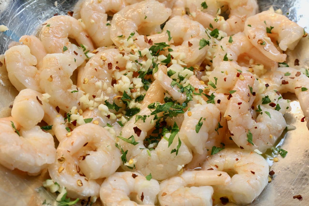 Toss cooked Air Fryer Frozen Shrimp in butter, garlic, chili and chopped parsley.