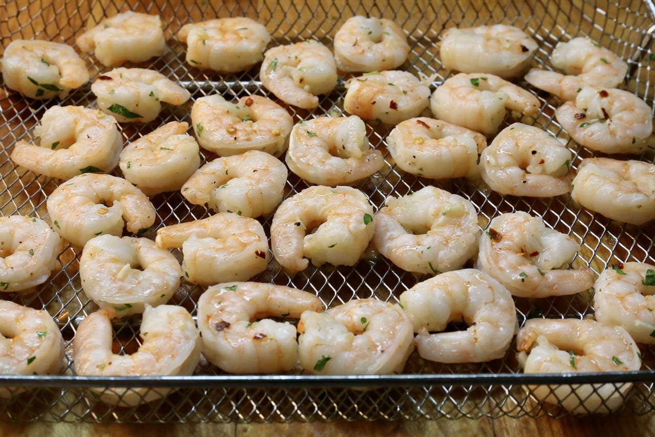 Return chili garlic shrimp to the air fryer until fully cooked.