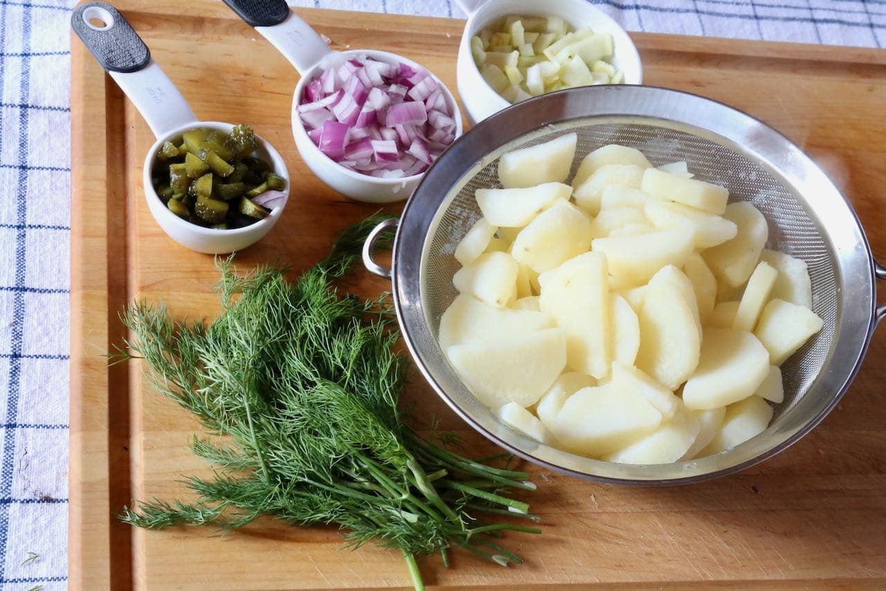 Erdapfelsalat is a warm Viennese Potato Salad featuring dill, gherkins, red onion and celery.