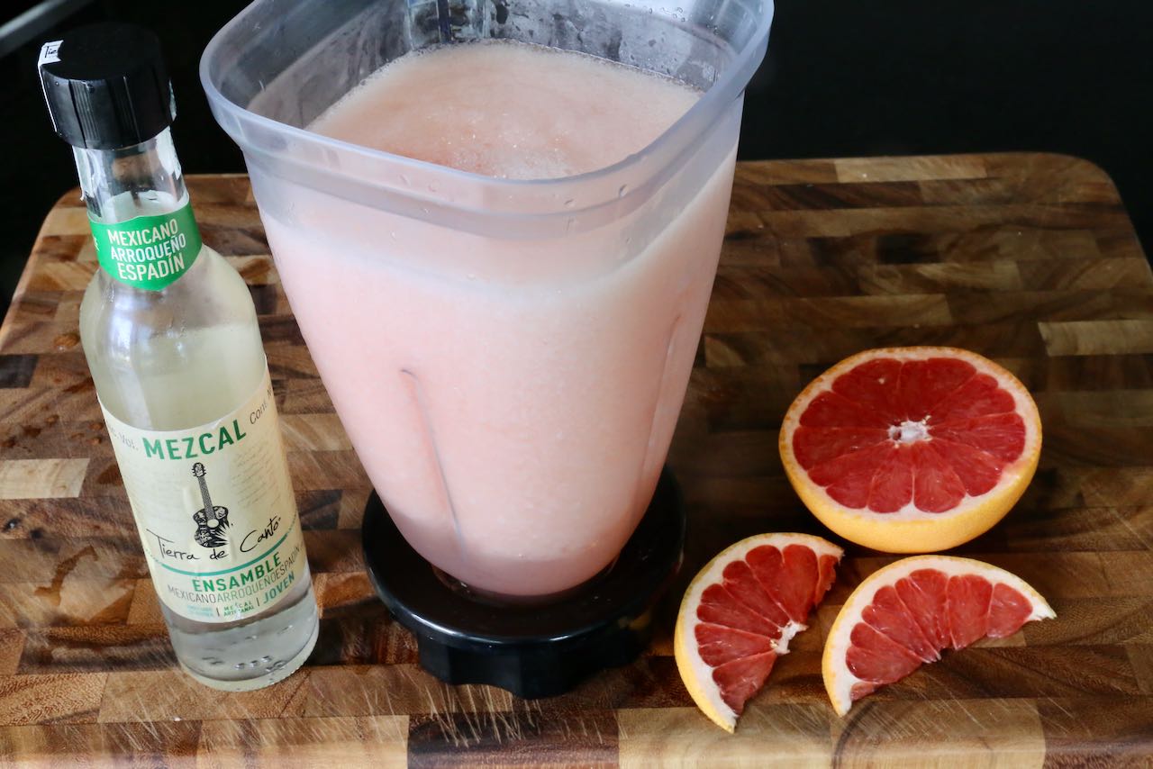 Prepare a Frozen Mezcal Paloma in a blender until it achieves a smooth slushie texture. 