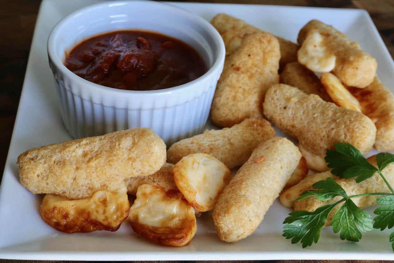 Serve crunchy homemade Air Fryer Frozen Mozzarella Cheese Sticks with marinara tomato sauce for dipping. 