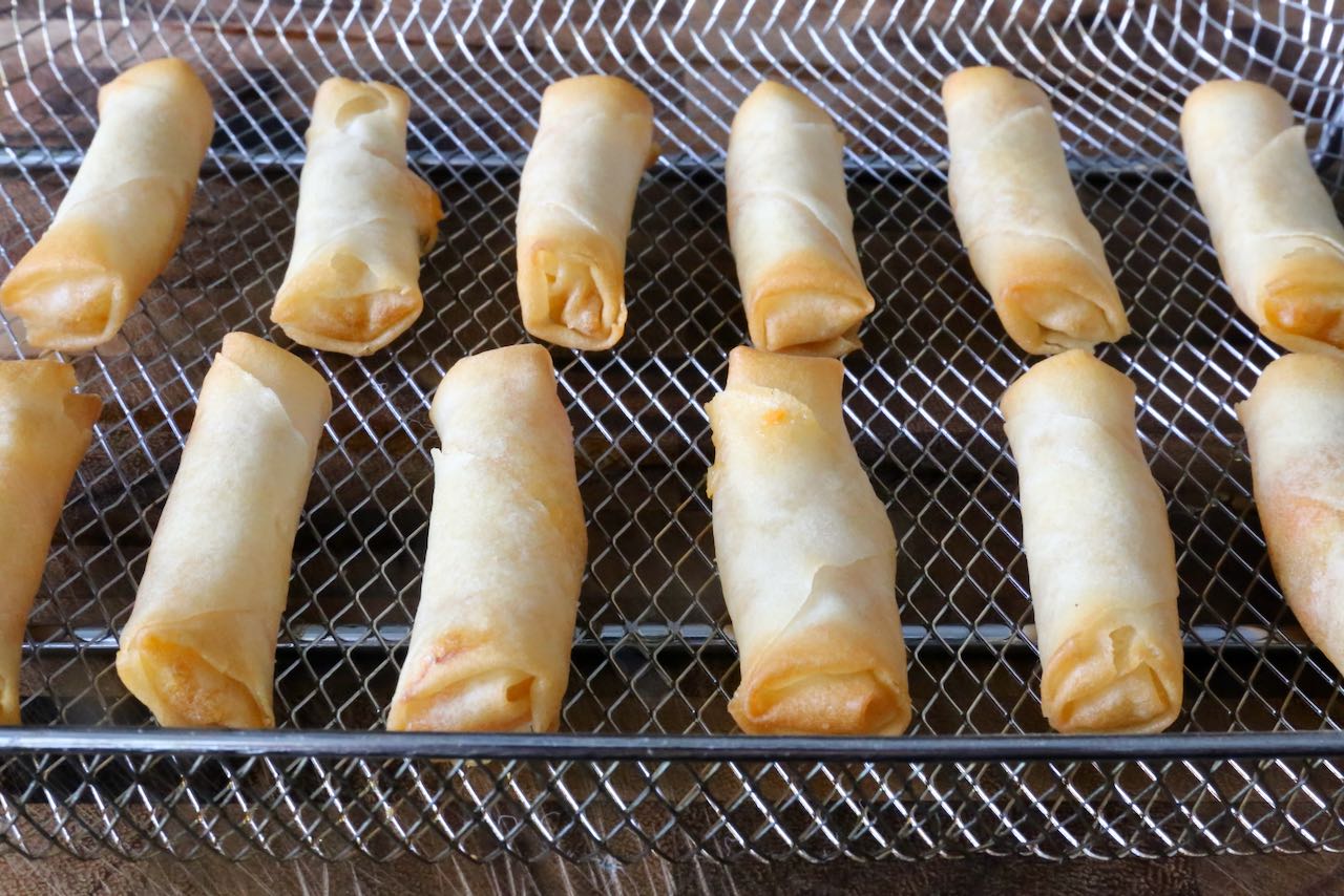 Place Frozen Spring Rolls in an Air Fryer basket in a single layer, ensuring they don't touch. 
