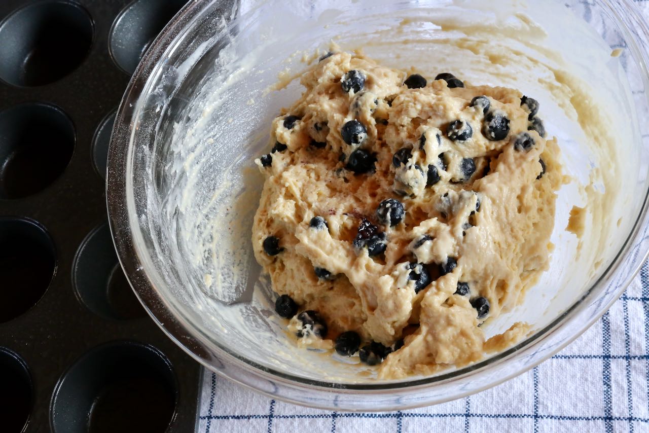 Gently stir fresh blueberries into smooth lemon ricotta muffin batter.