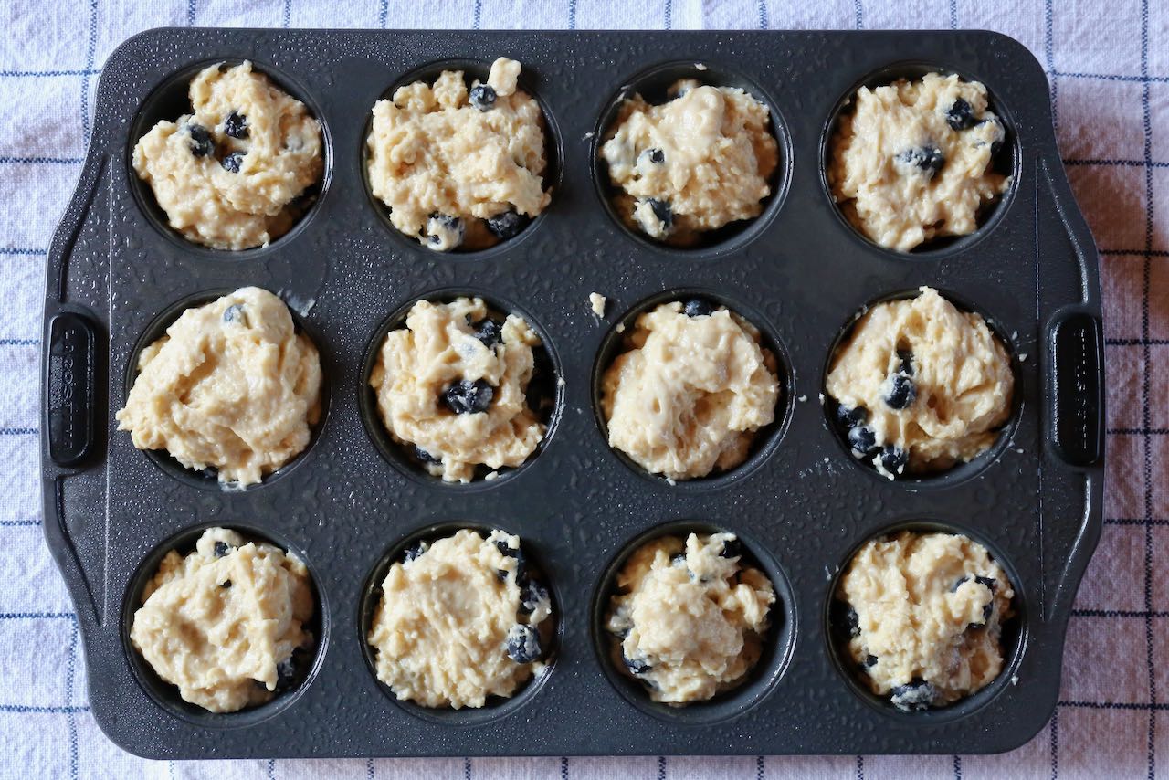 Scoop Blueberry Ricotta Muffin batter into greased tins.