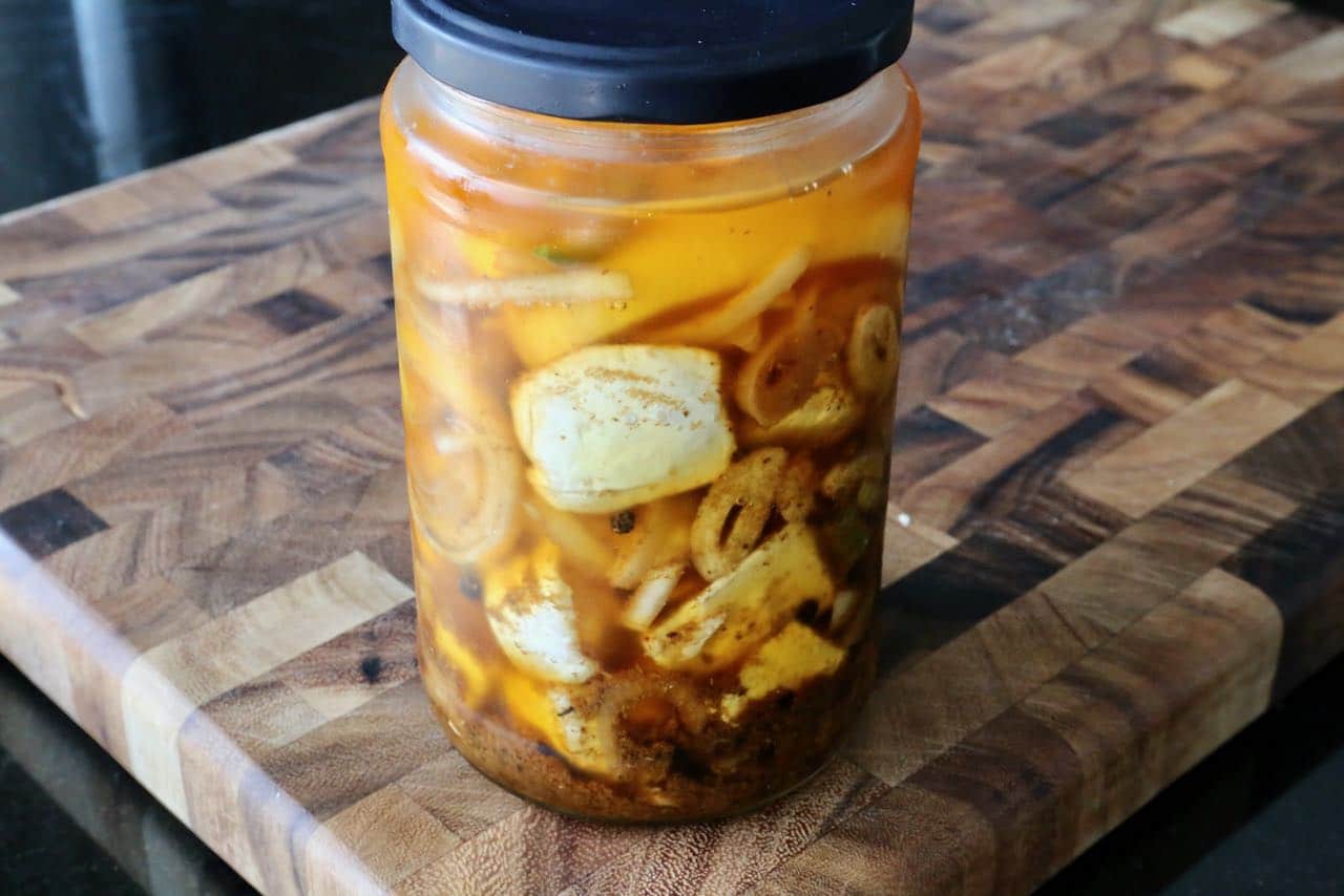 Store Nakladany Hermelin in a large mason jar or glass container in the fridge.