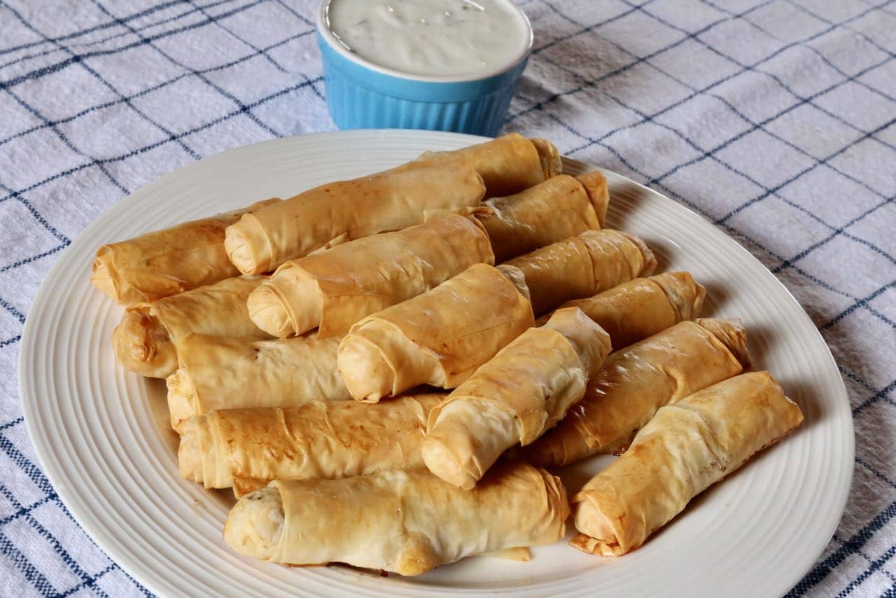 Serve homemade Sigara Börek with garlic and parsley yogurt sauce for dipping.