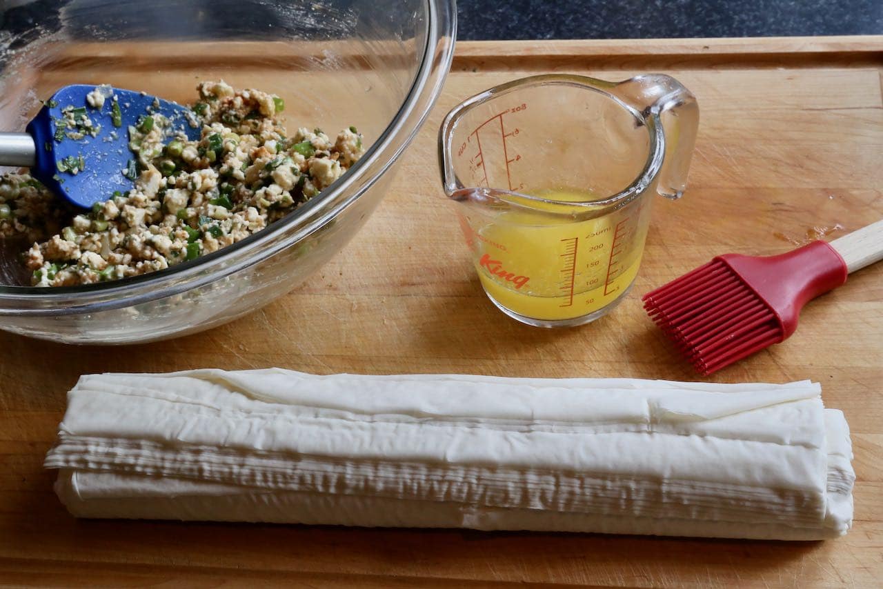 Sigara Börek Assembly: filo sheets, cheese herb filling, melted butter and pastry brush.