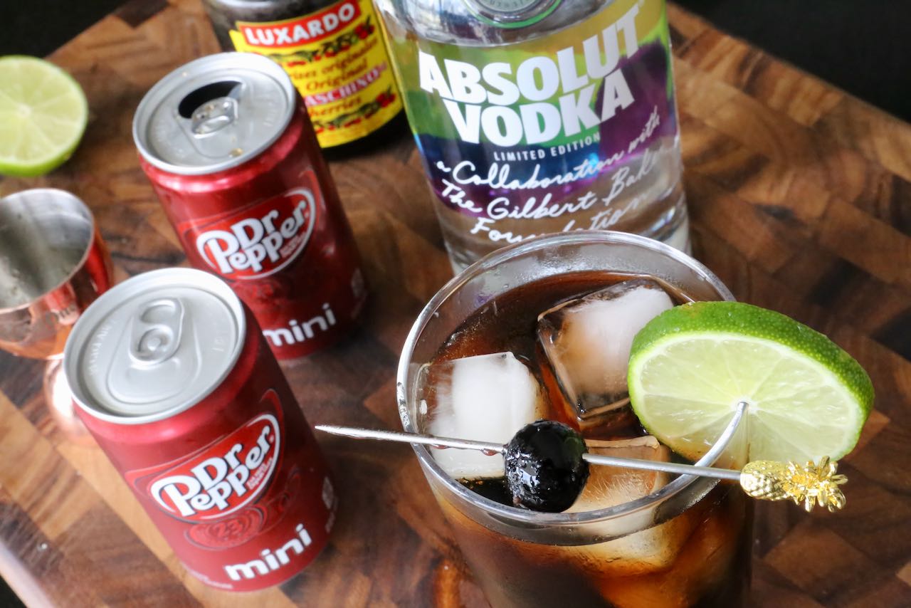 Garnish an easy Vodka and Dr Pepper drink with a lime wheel and cherry.