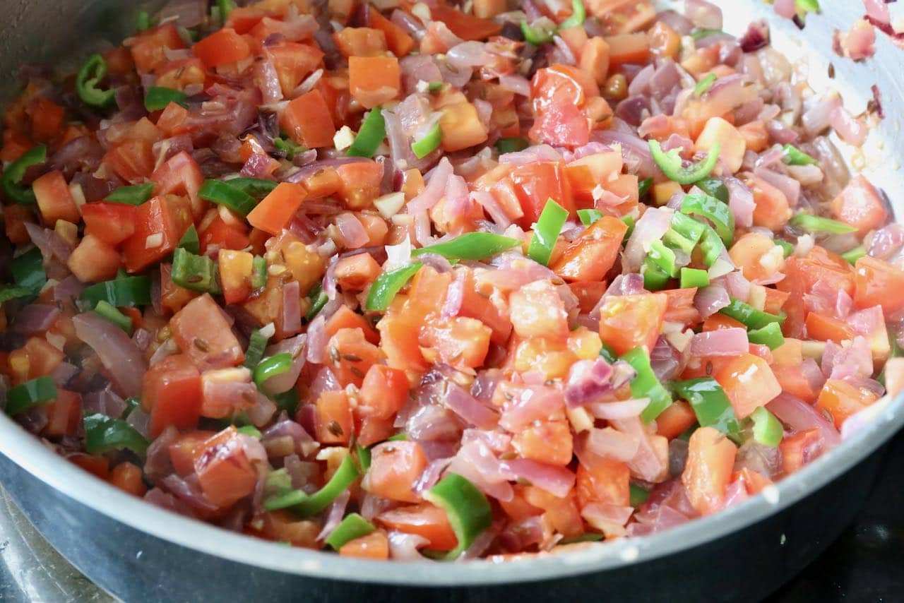 Saute vegetables and spices in a large skillet.