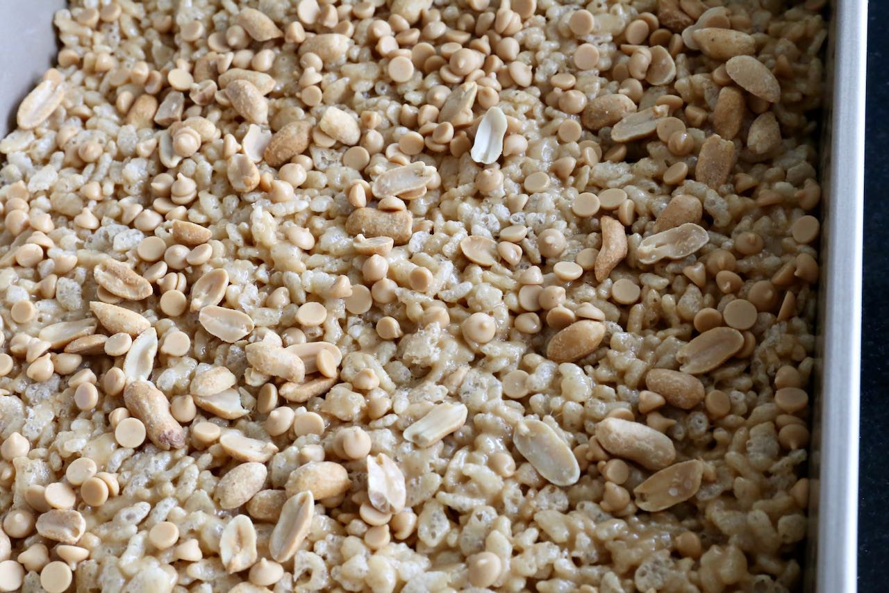 Decorate Peanut Butter Rice Krispies with roasted peanuts and peanut butter chips.