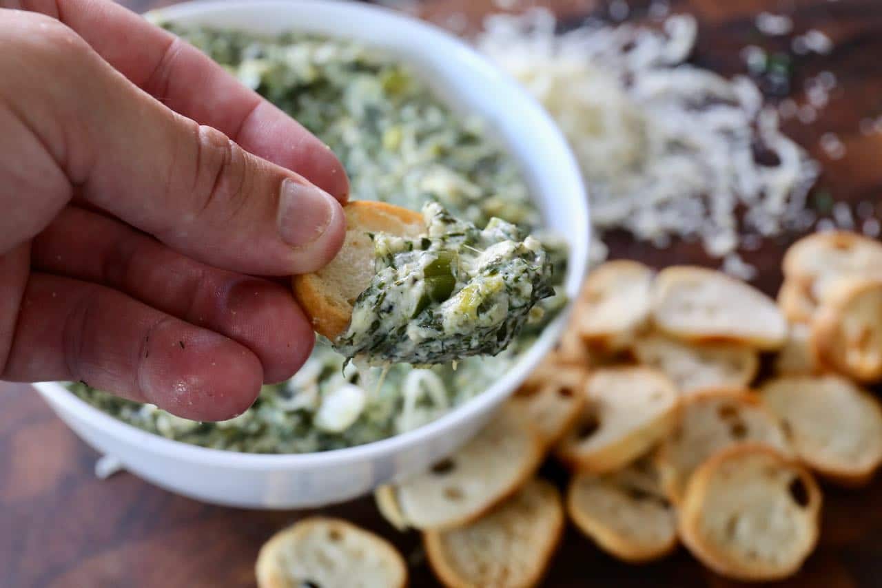 Scoop Spanakopita Dip with pita, bagel chips or crostini.