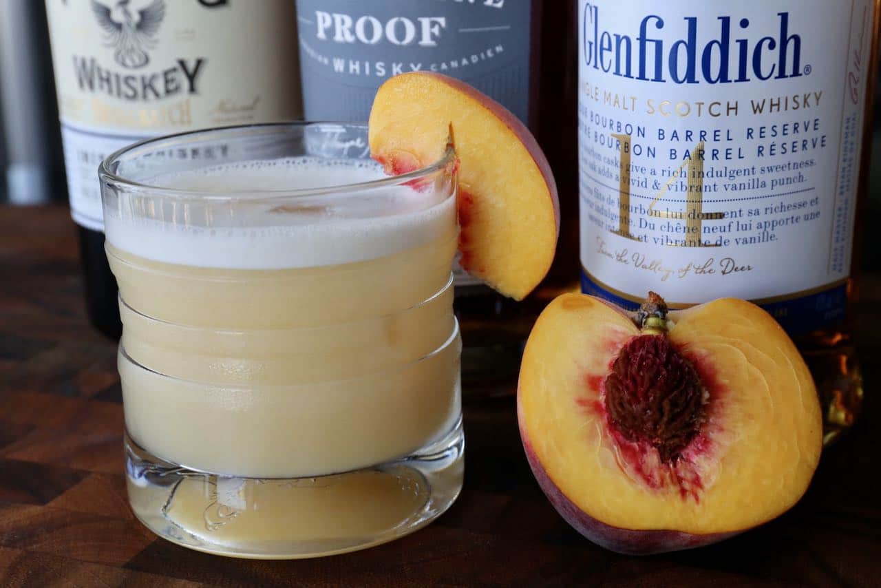 Peach Whiskey Sour made with egg white adds a creamy foam to the top of the drink. 