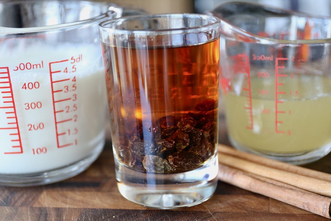 Homemade Vegan Eggnog is prepared with almond milk, brandy and rum soaked raisins and aquafaba.