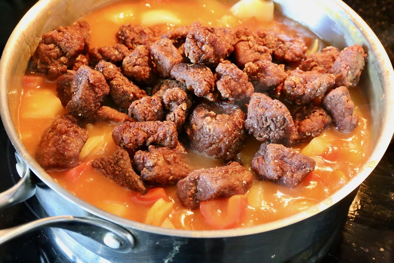 Toss deep fried pork in sweet and sour sauce.