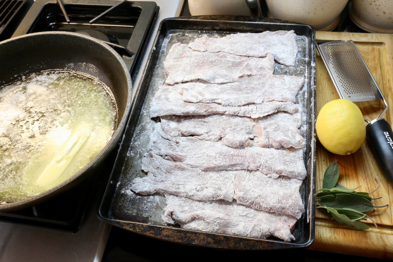 Toss veal slices in flour then shallow fry in a skillet with melted butter.