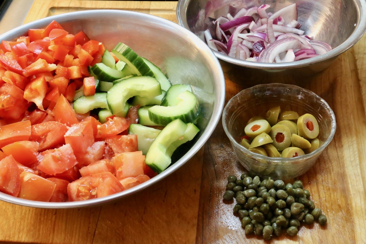 Toss Pipirrana recipe ingredients in a salad bowl.