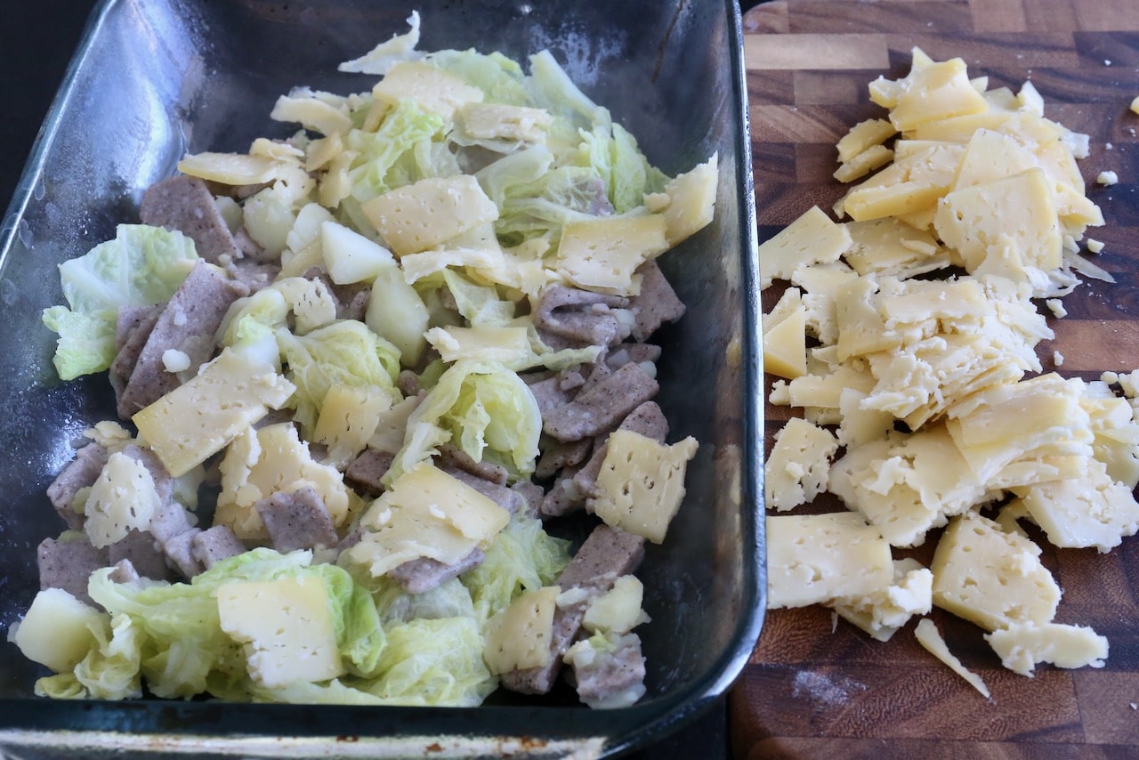 Layer Pizzoccheri alla Valtellinese in a casserole dish with buckwheat pasta, cabbage, potato and bitto cheese.