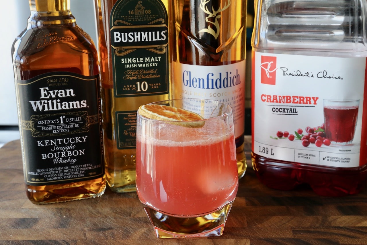 Garnish this easy Cranberry Whiskey Cocktail with a dehydrated citrus wheel.