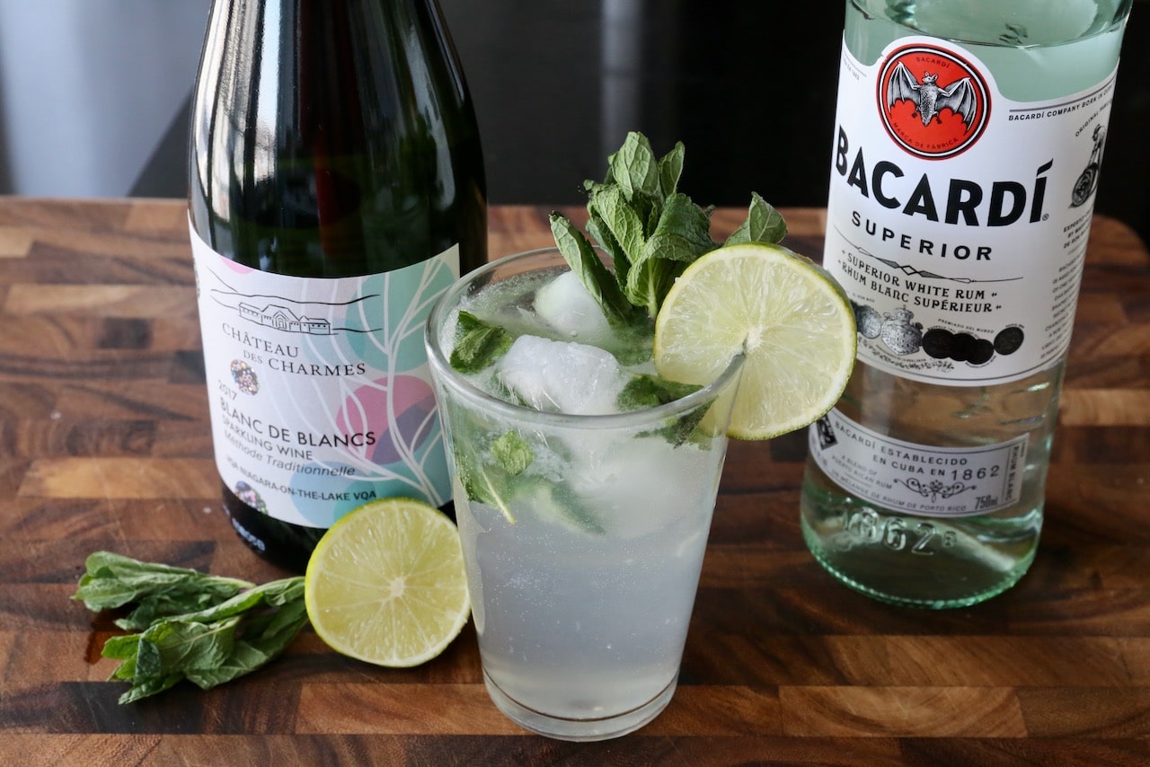 Garnish Mojito Royale Cocktail with fresh mint sprig and lime wheel.