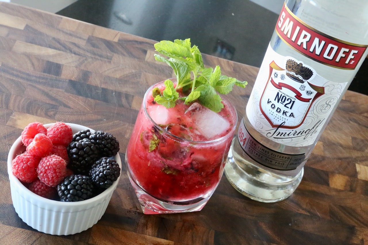 Garnish this Berry Vodka Cocktail with a fresh sprig of mint.