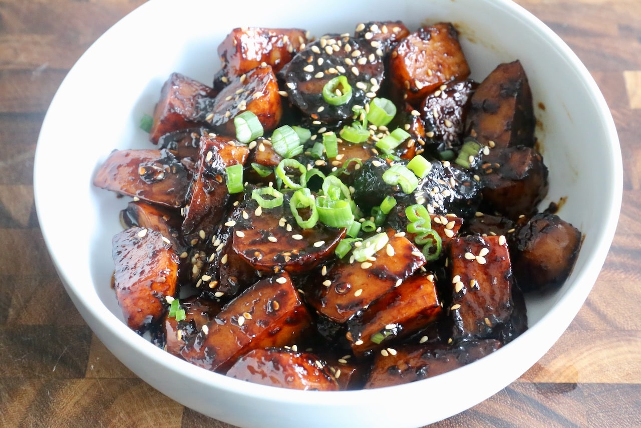 Serve Gamja Jorim garnished with sesame seeds and finely chopped scallions.