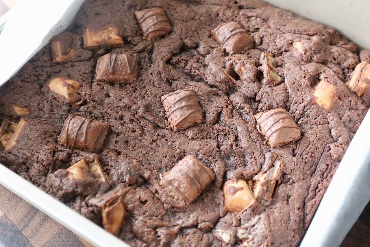Let Kinder Brownies cool before removing them from the tin using parchment paper. 
