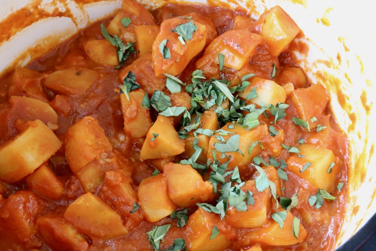 Flavour Patate in Umido with chili flakes and chopped basil.