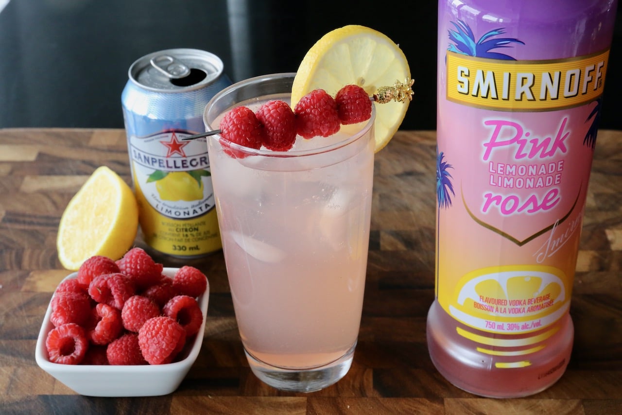 Serve Vodka Pink Lemonade in a Collins glass with ice, lemon wheel and fresh berries.