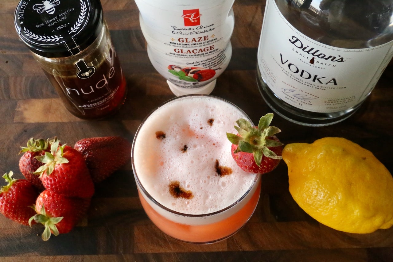 Decorate the egg white froth with drops of balsamic syrup or reduction.