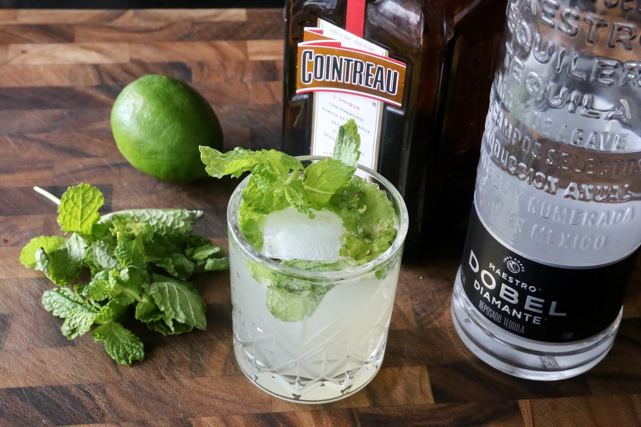 Garnish a Tequila Smash Cocktail with a sprig of fresh mint.