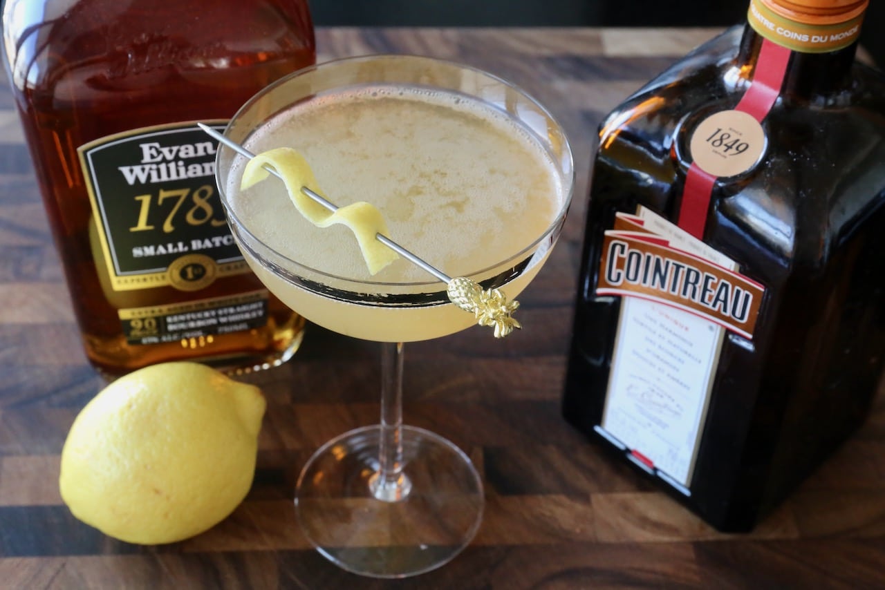 Garnish the cocktail with a lemon peel.