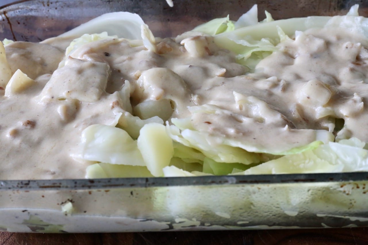 Smother cooked cabbage and potatoes in a creamy and cheesy sauce.