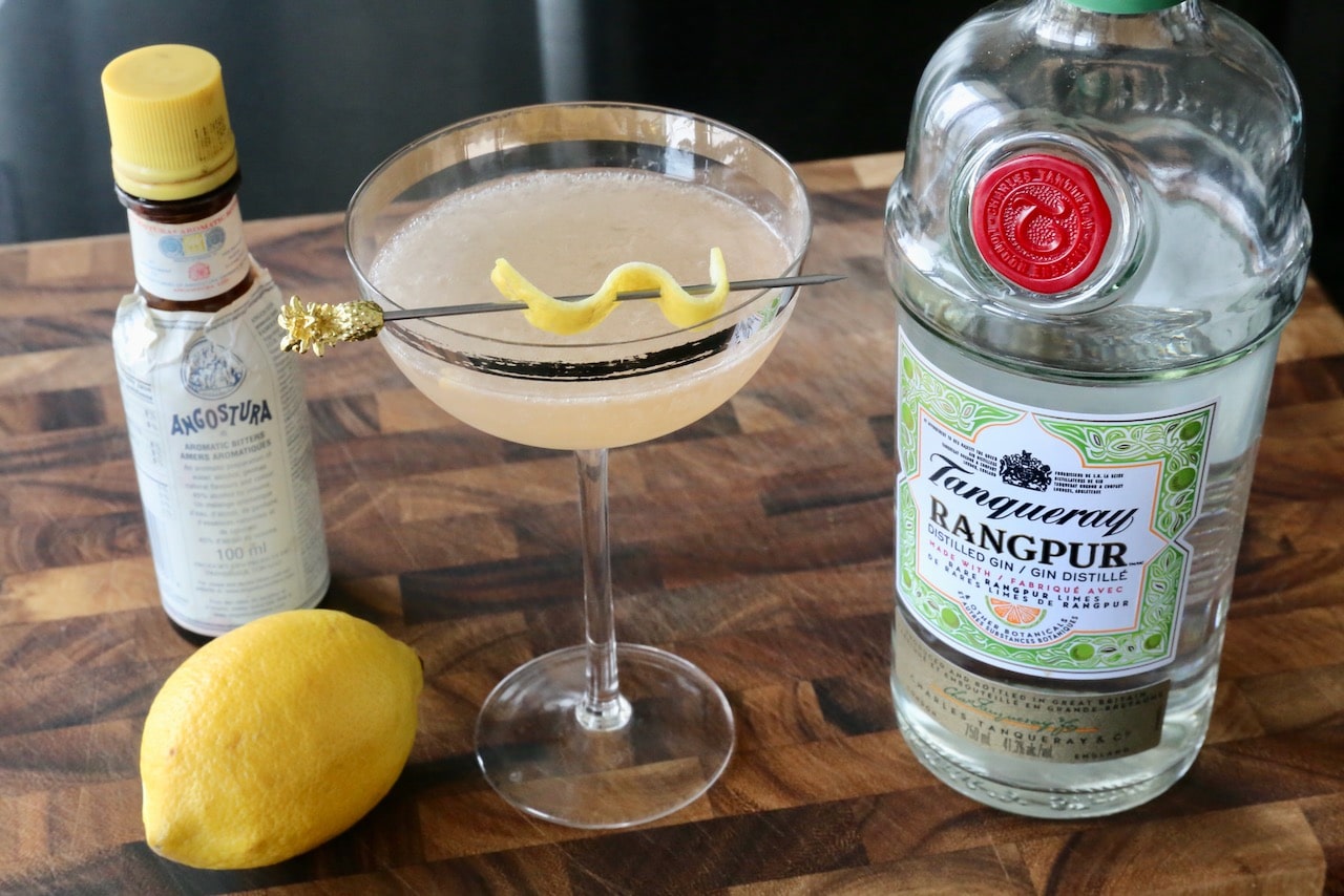 Garnish each coupe cocktail glass with a lemon twist.