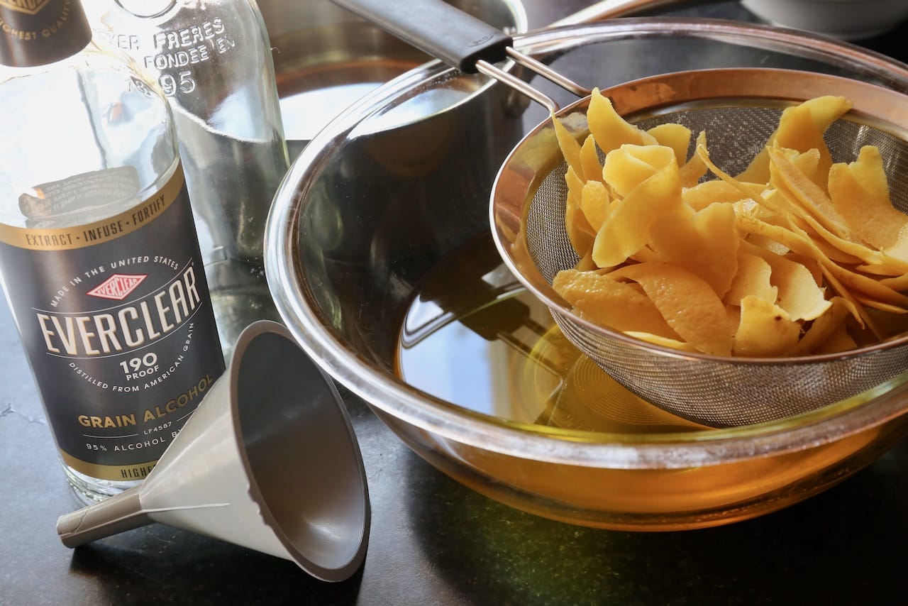 Pour the steeped lemon spirit through a strainer and discard the peels. 