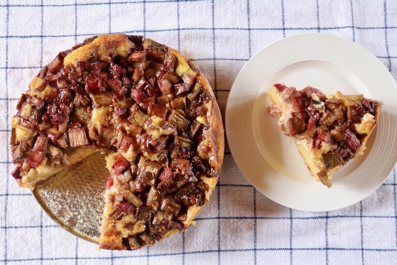 Serve a slice of Rabarberkage cake with vanilla or strawberry ice cream.