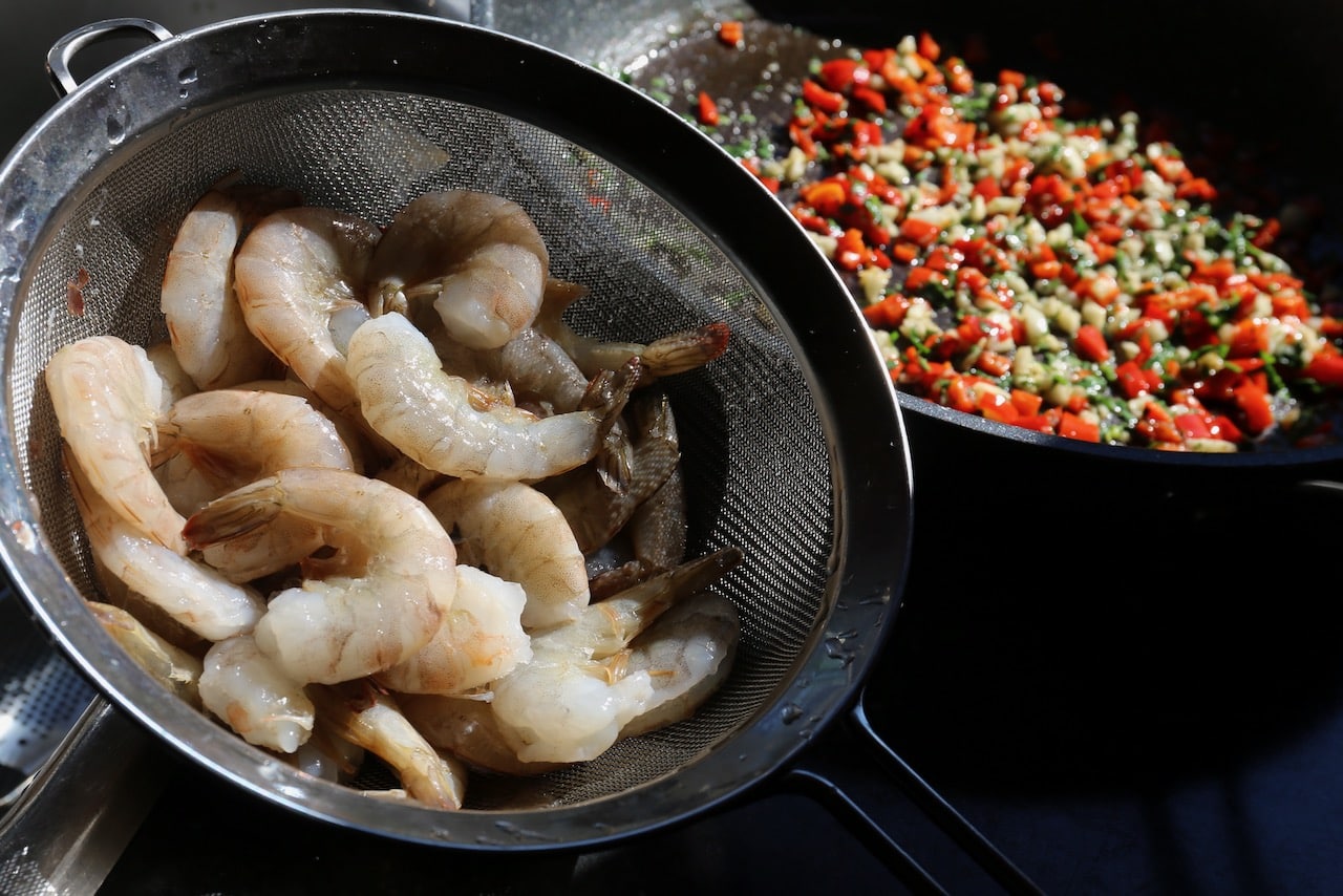 Cook raw prawns in a skillet with garlic, parsley and spicy chilli. 