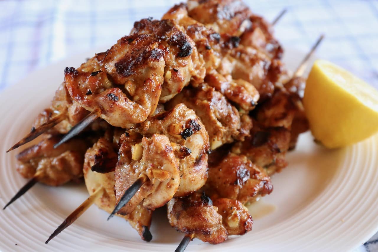 Serve Pakistani Chicken Tikka Kebab on a platter with a squeeze of lemon or lime.