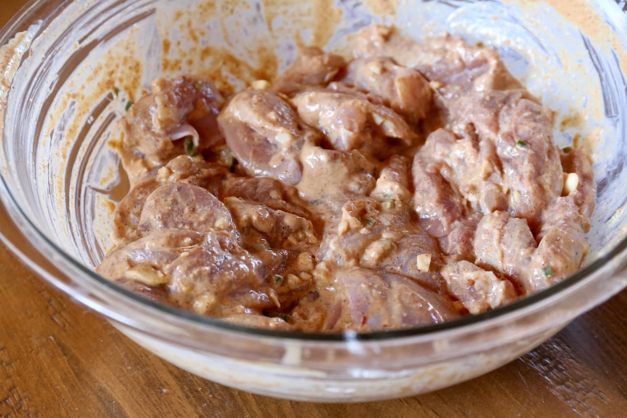 Combine chunks of chicken with Pakistani Tikka marinade in a large mixing bowl.