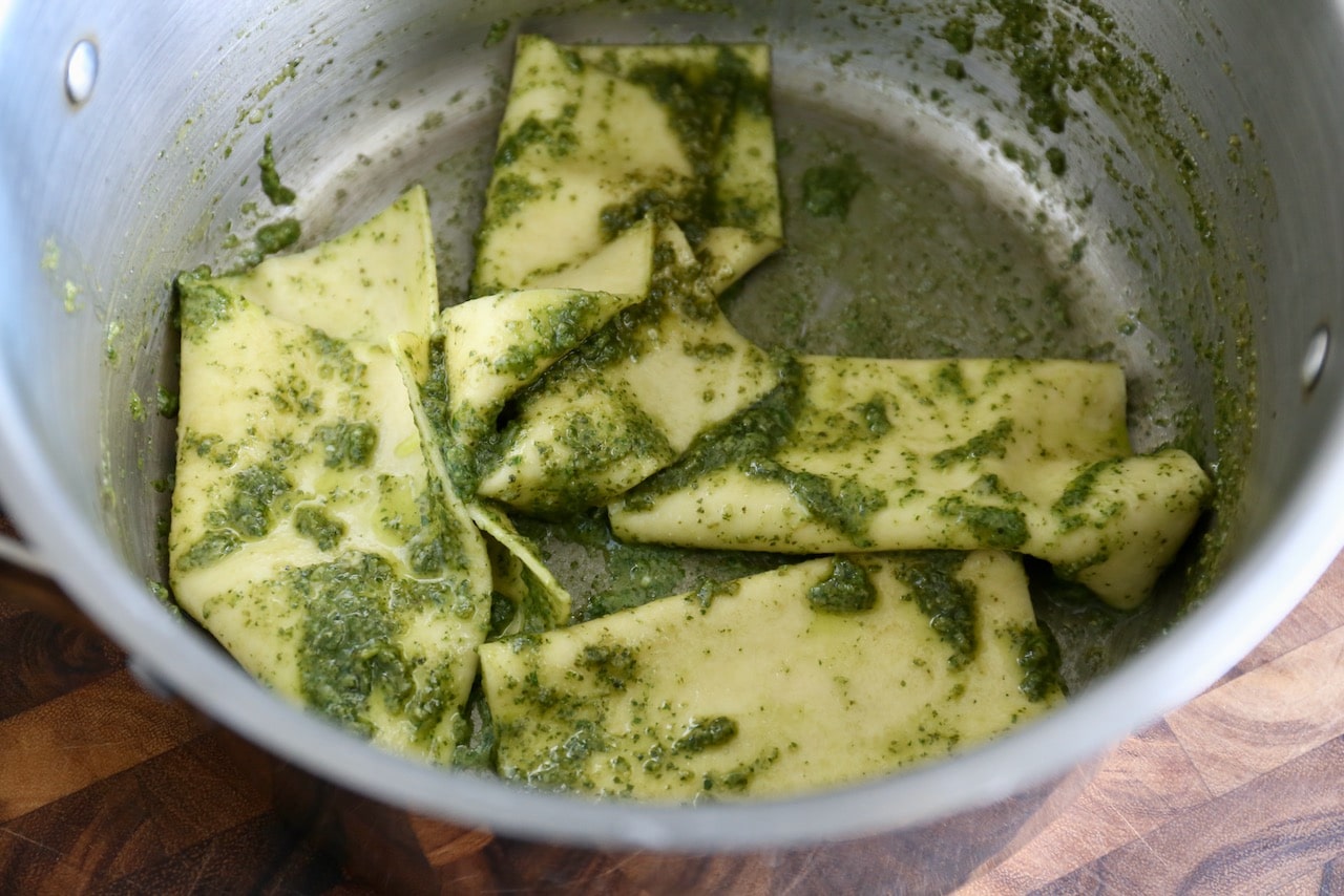 Toss Mandilli pasta sheets with pesto sauce in a large pot.