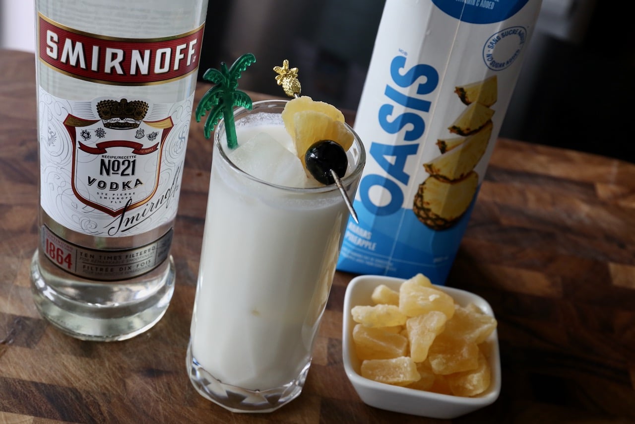 Serve this Pina Colada with Vodka recipe garnished with a cherry and candied pineapple.