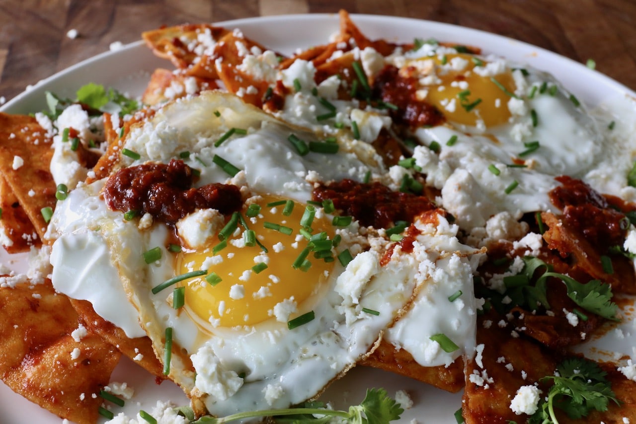 Serve this Red Chilaquiles recipe topped with fried eggs.v