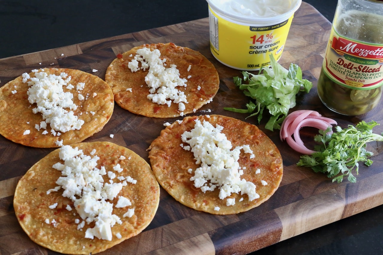Fill tortillas with crumbled queso cheese.