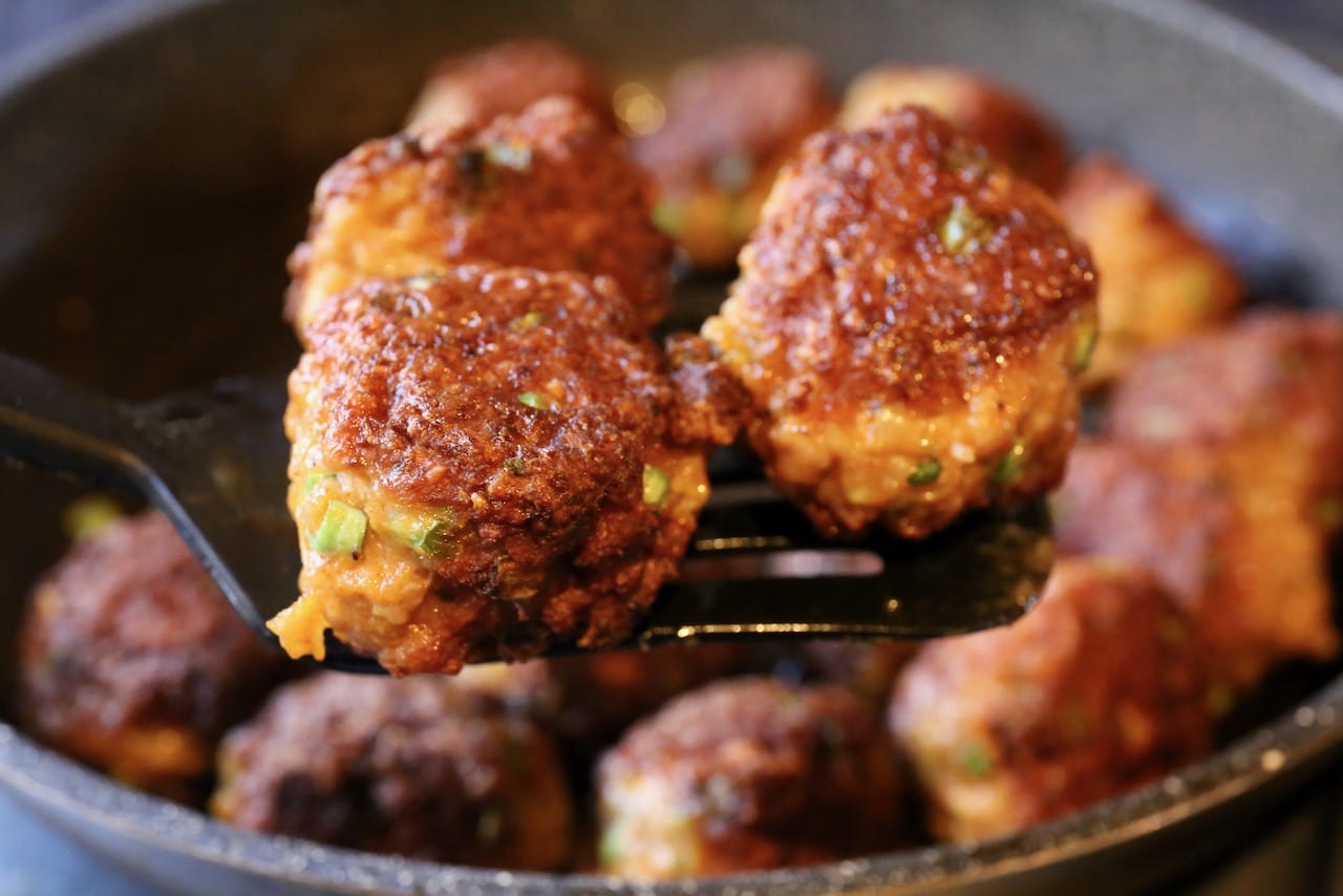 The meatballs are finished cooking when the exterior is browned and crispy.