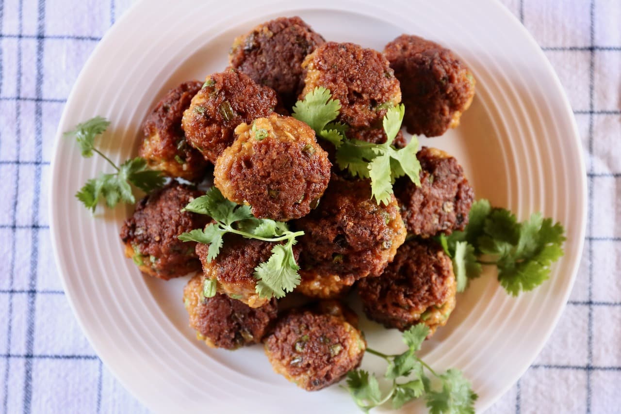 Serve Curry Pork Meatballs with chopped cilantro.
