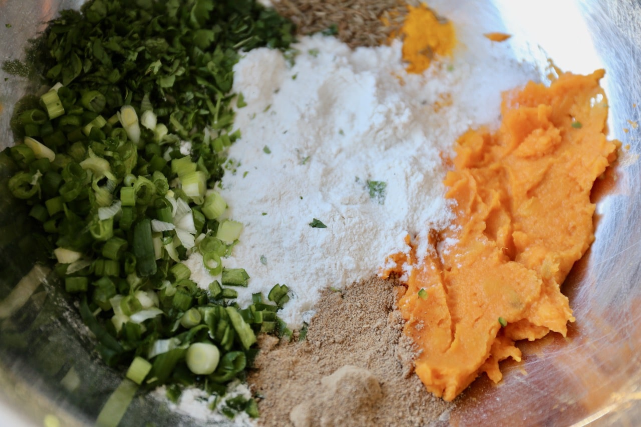Combine sweet potato, flour, spices and herbs in a large mixing bowl.