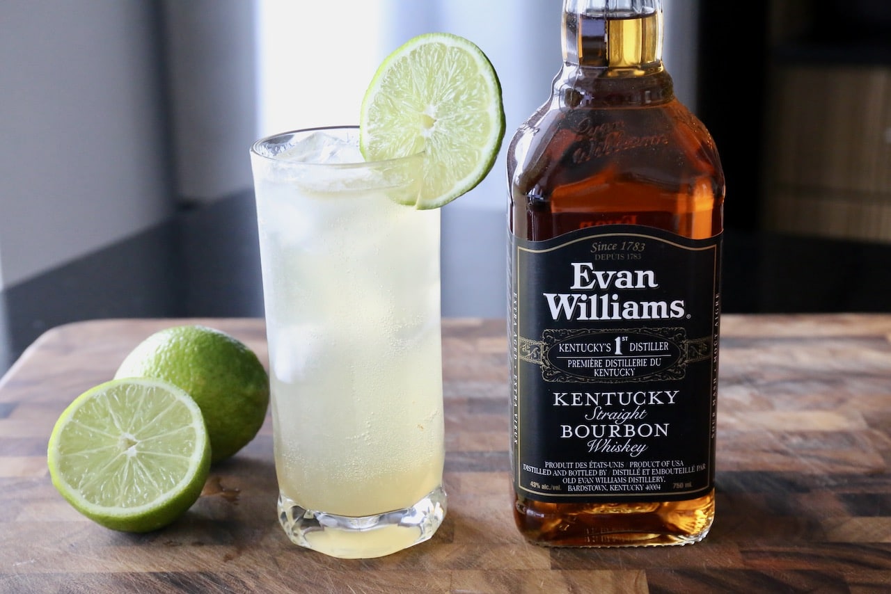 Serve a classic Rickey cocktail in an ice-filled Collins glass garnished with a lime wheel.